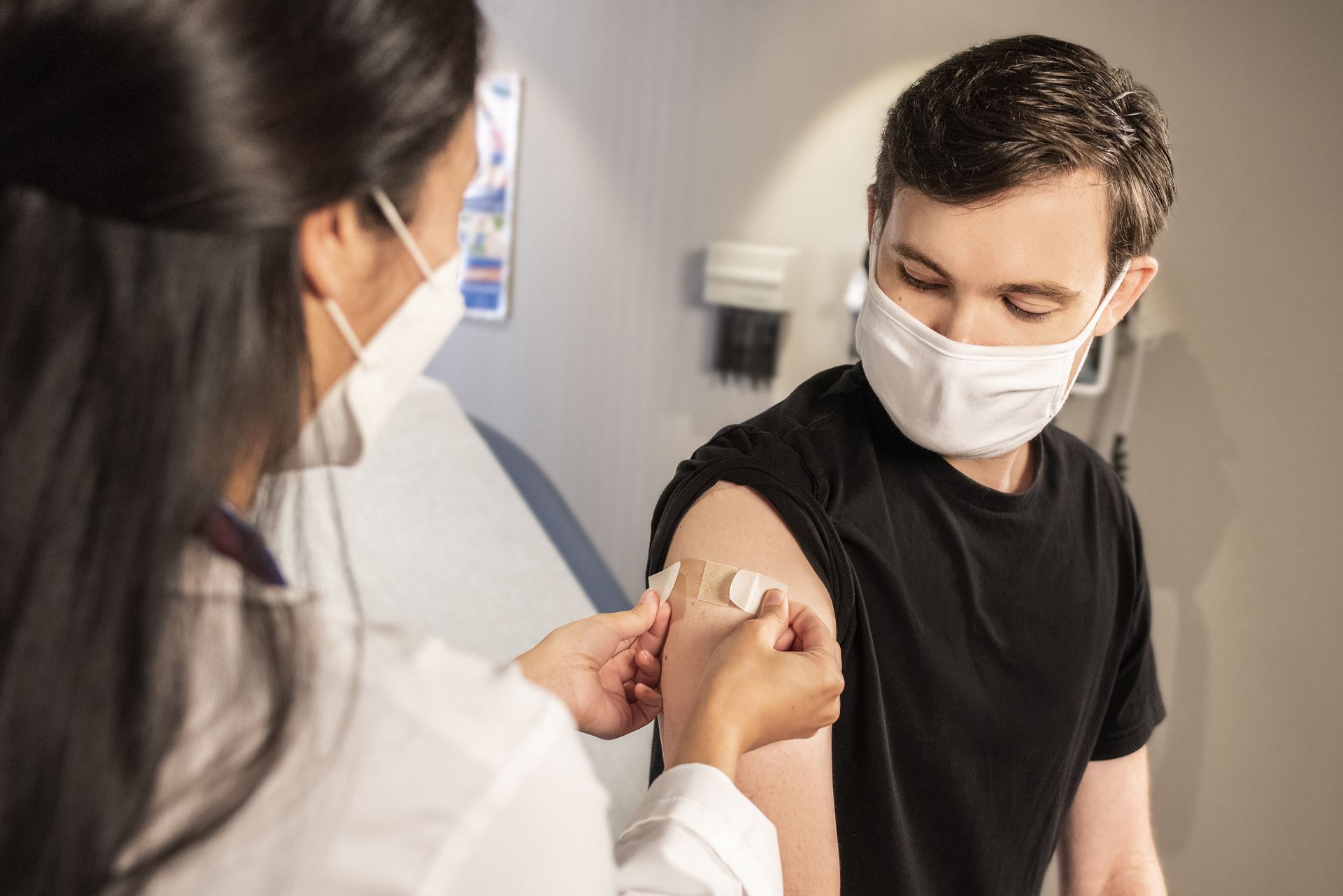 boy receiving vaccine from doctor